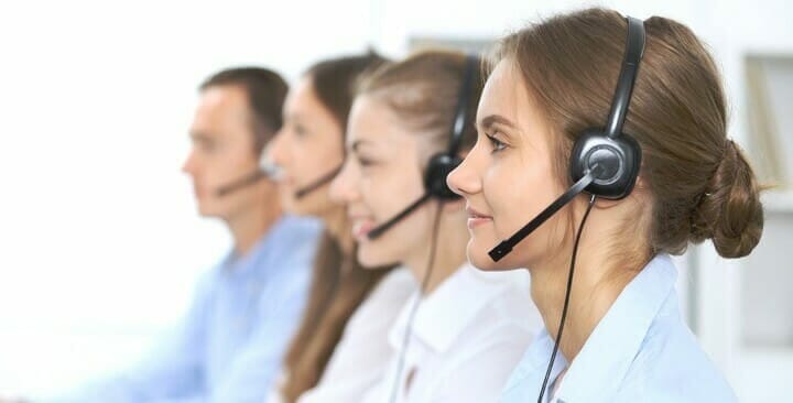 Call center operator in headset while consulting client. Telemarketing or phone sales. Customer service and business concept